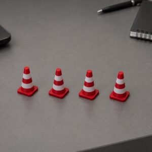 May include: Four miniature traffic cones arranged in a horizontal row. Each cone features a bright red base and top with two distinct white horizontal stripes encircling the body. The cones have a square base and a smooth, matte finish.