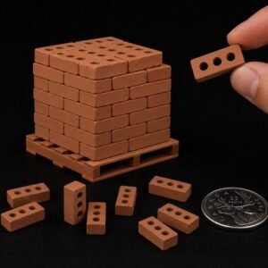 May include: A miniature stack of terracotta-coloured bricks arranged on a small plastic pallet, with several loose bricks scattered nearby and a Canadian 25-cent coin for scale. One individual brick is held up to show three circular holes.