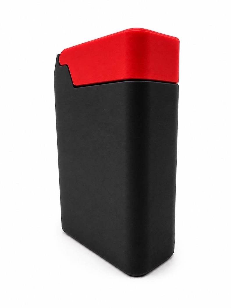 Packout Inspired Cigarette Case (King size / cigarette 8) May include: A rectangular storage container with a matte black body and a contrasting bright red lid. The container features a smooth, solid-coloured finish with rounded corners and a vertical orientation, presenting a clean and simple design.