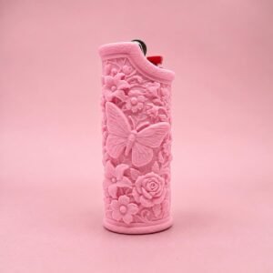 May include: A light pink lighter featuring a raised, textured relief design of a central butterfly surrounded by various flowers and foliage. The lighter has a metallic ignition mechanism at the top with a small red component visible.