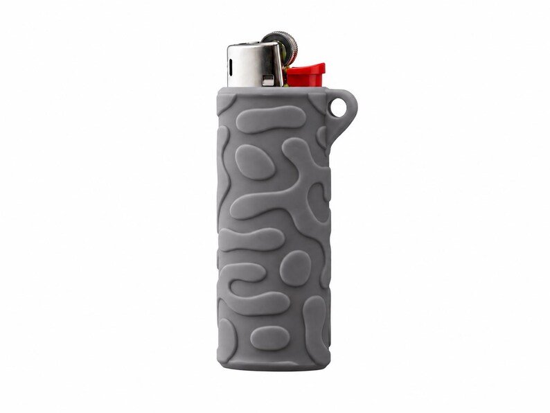 BIC Lighter Keychain Sleeve May include: A grey lighter encased in a silicone sleeve featuring a raised, organic, amoeba-like pattern. The lighter has a metallic top with a red ignition button and a small circular loop extending from the side of the textured silicone cover.