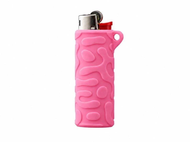 BIC Lighter Keychain Sleeve May include: A pink lighter encased in a textured silicone sleeve featuring an embossed, irregular organic pattern. The lighter has a metallic silver top mechanism with a red ignition button and a small circular loop integrated into the sleeve.